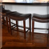 F35. 4 Leather top stools with nailhead trim. 25”h x 20”w x 16”d 